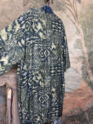 Boho patchwork denim cardigan with floral and aztec prints, large patch pockets, open front, styled with green necklace - 9