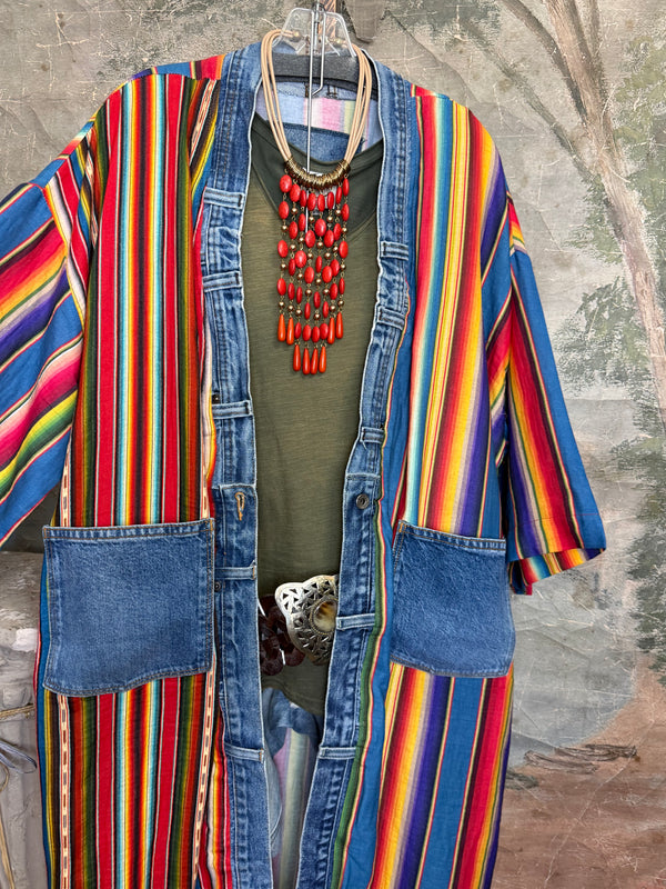 Boho serape striped duster cardigan with denim pockets, styled with red bead necklace and belt on mannequin - 9