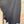 Load image into Gallery viewer, Long black sleeveless open front duster vest styled with graphic tee, gingham pants, and black beaded necklace on hanger - 6
