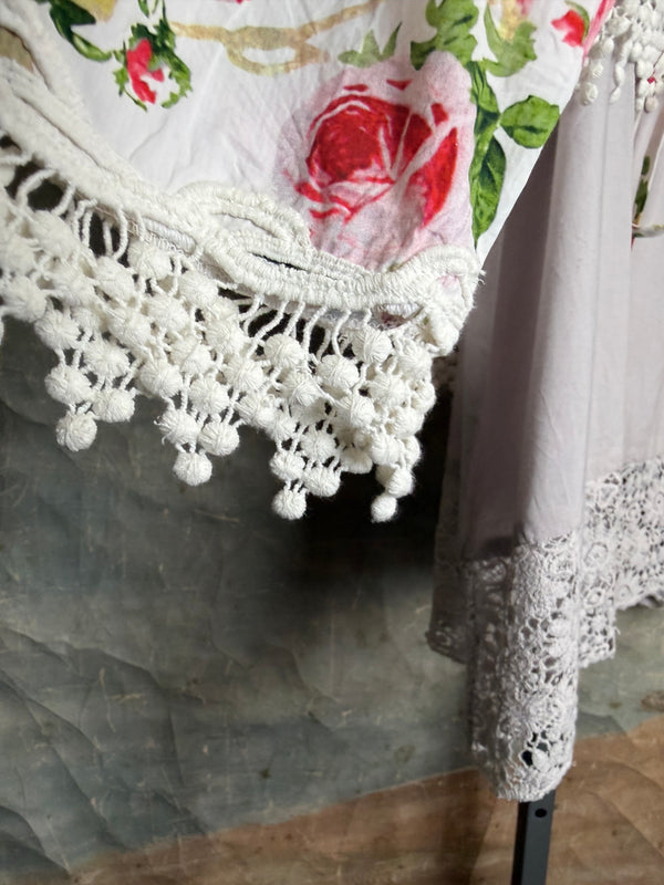 White floral kimono cardigan with pink roses and crochet lace trim displayed over gray tank top on hanger - 7