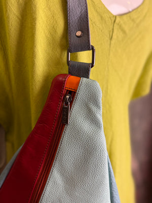 Soruka multicolor leather sling crossbody bag in light blue, red, and teal with orange zipper detail - 2