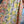 Load image into Gallery viewer, Woman wearing DYM90081 Bloomspell Maxi Dress in orange floral print with pink Converse sneakers in boutique setting - 8
