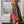 Load image into Gallery viewer, Woman wearing Stella Cardigan 5860 with rainbow serape stripes, denim trim, ruffle hem, and bell sleeves over white tee - 2
