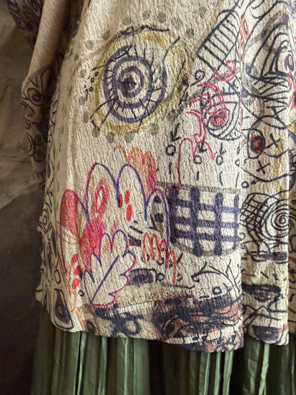 Boho waffle knit tunic top with abstract art print in earthy tones, styled with colorful chain necklace on mannequin - 6