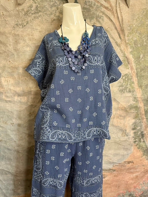 Blue bandana paisley print muslin V-neck top on mannequin with layered blue wooden bead necklace - 15