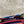 Load image into Gallery viewer, Goruka Grace Reversible Loop-B colorblock leather bag in blue, burgundy, orange with zebra print strap on stone column - 5
