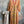 Load image into Gallery viewer, Woman wearing DYM90081 Bloomspell Maxi Dress in orange floral print with pink Converse sneakers in boutique setting - 3
