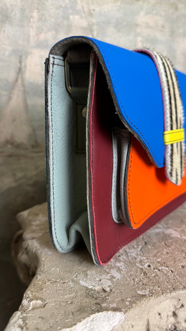 Goruka Grace Reversible Loop-B colorblock leather bag in blue, burgundy, orange with zebra print strap on stone column - 8
