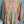 Load image into Gallery viewer, Woman wearing DYM90081 Bloomspell Maxi Dress in orange floral print with pink Converse sneakers in boutique setting - 12
