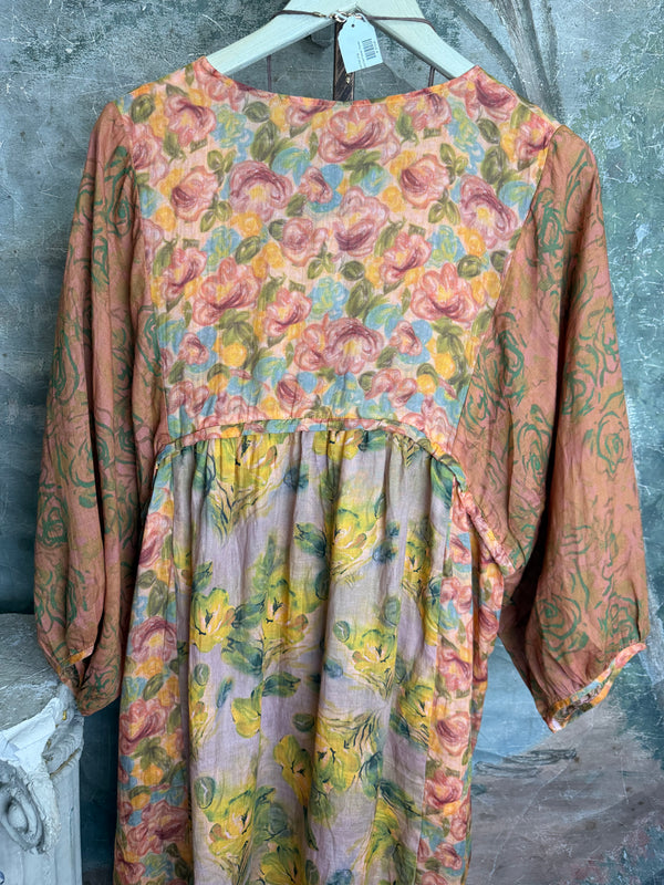 Woman wearing DYM90081 Bloomspell Maxi Dress in orange floral print with pink Converse sneakers in boutique setting - 12