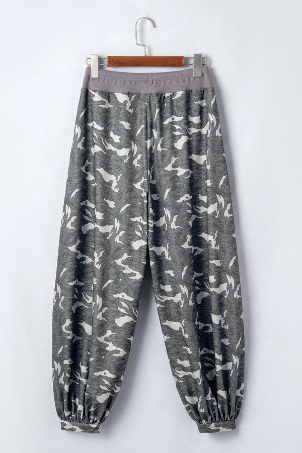 Woman wearing gray camouflage cargo jogger pants with patch pockets and white crop top, casual street style outfit - 3