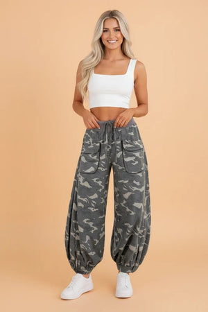 Woman wearing gray camouflage cargo jogger pants with patch pockets and white crop top, casual street style outfit - 1