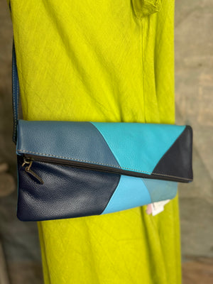 Mila color-block crossbody bag in teal, blue, and navy leather with turquoise strap, styled on mannequin with lime dress - 2