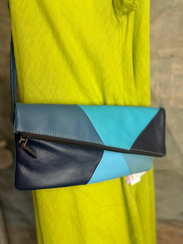 Mila color-block crossbody bag in teal, blue, and navy leather with turquoise strap, styled on mannequin with lime dress - 2