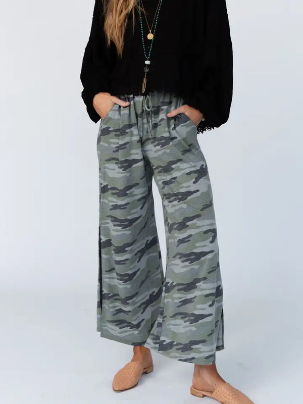 Woman wearing TBN6292 Wanderer Wide Leg Camo Pants with black top and layered necklaces, wide leg silhouette - 1