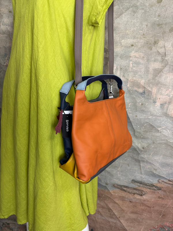Soruka orange multicolor leather crossbody bag with gray strap on lime green linen dress mannequin - 6