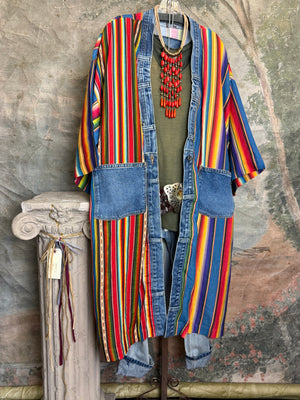 Boho serape striped duster cardigan with denim pockets, styled with red bead necklace and belt on mannequin - 1