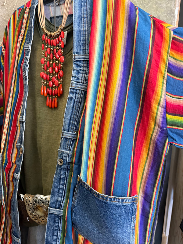 Boho serape striped duster cardigan with denim pockets, styled with red bead necklace and belt on mannequin - 13