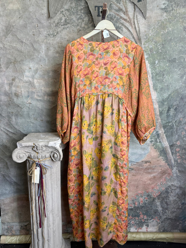 Woman wearing DYM90081 Bloomspell Maxi Dress in orange floral print with pink Converse sneakers in boutique setting - 10
