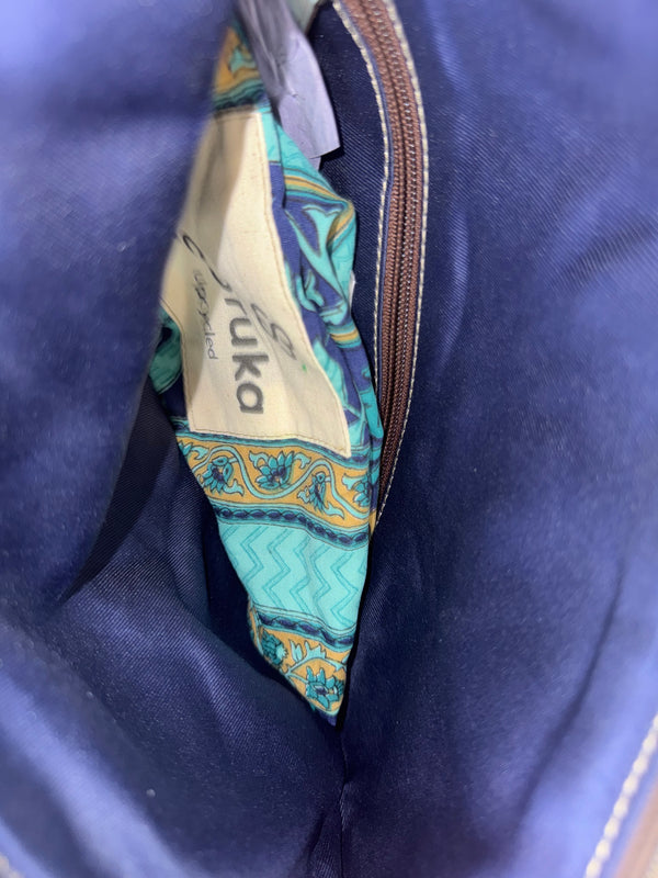 Mila color-block crossbody bag in teal, blue, and navy leather with turquoise strap, styled on mannequin with lime dress - 27