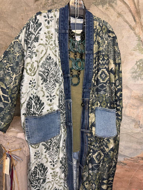 Boho patchwork denim cardigan with floral and aztec prints, large patch pockets, open front, styled with green necklace - 2