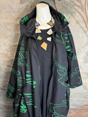Black oversized hooded maxi jacket with green abstract scribble print, gathered back detail, long sleeves, shown on mann - 7