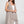 Load image into Gallery viewer, Long black sleeveless open front duster vest styled with graphic tee, gingham pants, and black beaded necklace on hanger - 11
