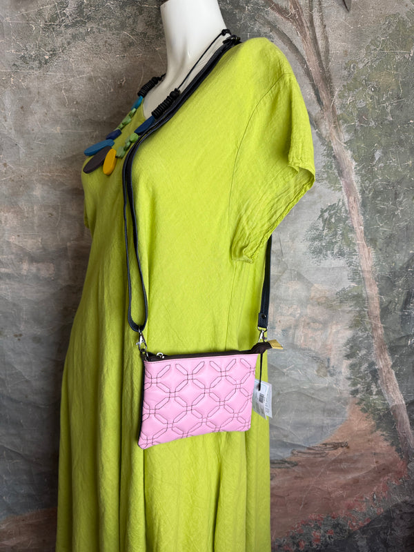 Pink leather quilted crossbody bag with geometric stitching pattern and black adjustable strap on lime green dress - 9