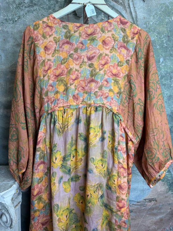 Woman wearing DYM90081 Bloomspell Maxi Dress in orange floral print with pink Converse sneakers in boutique setting - 11