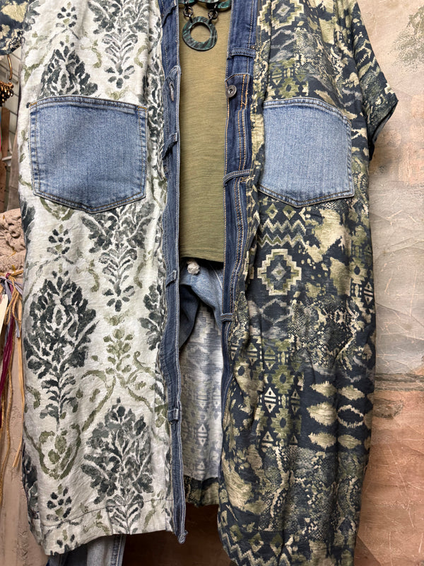 Boho patchwork denim cardigan with floral and aztec prints, large patch pockets, open front, styled with green necklace - 11