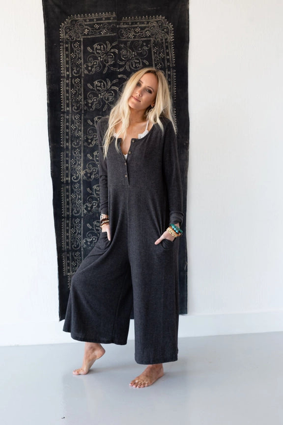 Woman wearing TBN3980 Comfort Jumpsuit in charcoal gray, long sleeve wide leg style with button front detail - 3
