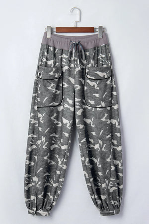 Woman wearing gray camouflage cargo jogger pants with patch pockets and white crop top, casual street style outfit - 2