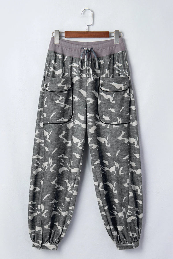 Woman wearing gray camouflage cargo jogger pants with patch pockets and white crop top, casual street style outfit - 2