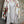 Load image into Gallery viewer, White floral kimono cardigan with pink roses and crochet lace trim displayed over gray tank top on hanger - 1
