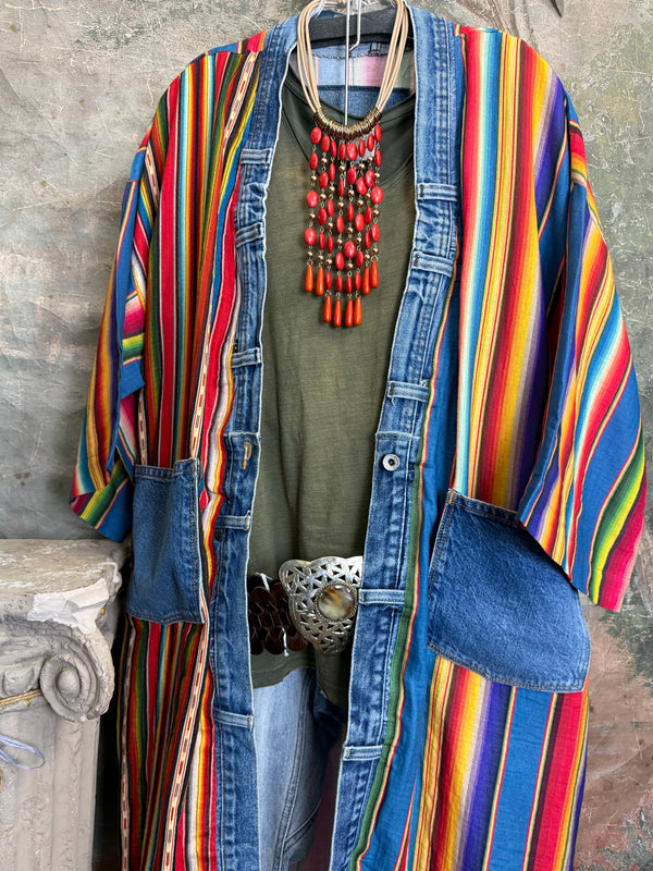 Boho serape striped duster cardigan with denim pockets, styled with red bead necklace and belt on mannequin - 14