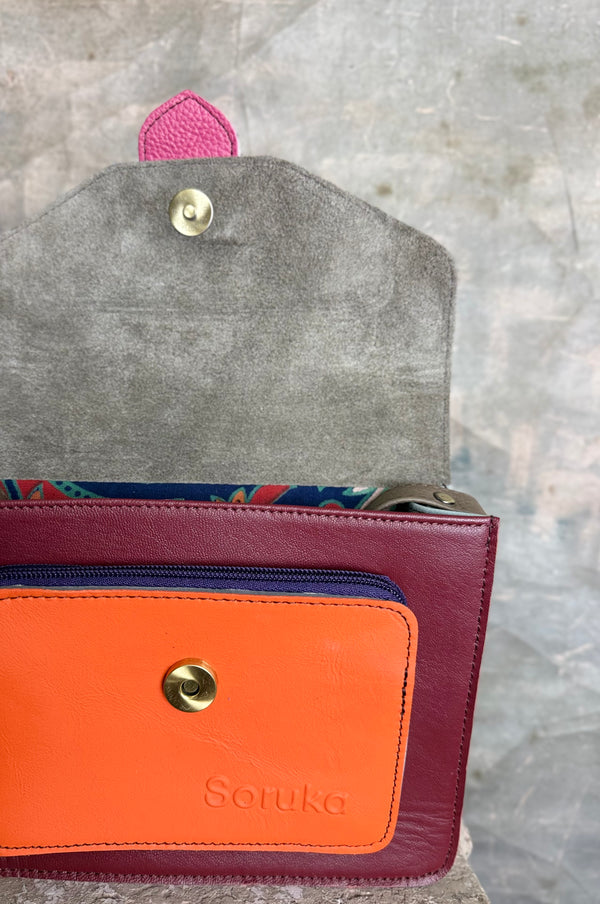 Goruka Grace Reversible Loop-B colorblock leather bag in blue, burgundy, orange with zebra print strap on stone column - 4