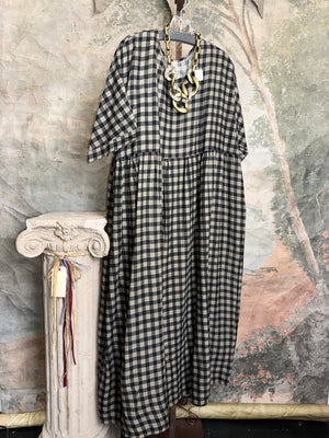 Black and cream gingham check relaxed silhouette maxi dress with chunky gold chain necklace on decorative column display - 1