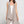Load image into Gallery viewer, Long black sleeveless open front duster vest styled with graphic tee, gingham pants, and black beaded necklace on hanger - 12
