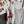 Load image into Gallery viewer, White floral kimono cardigan with pink roses and crochet lace trim displayed over gray tank top on hanger - 6
