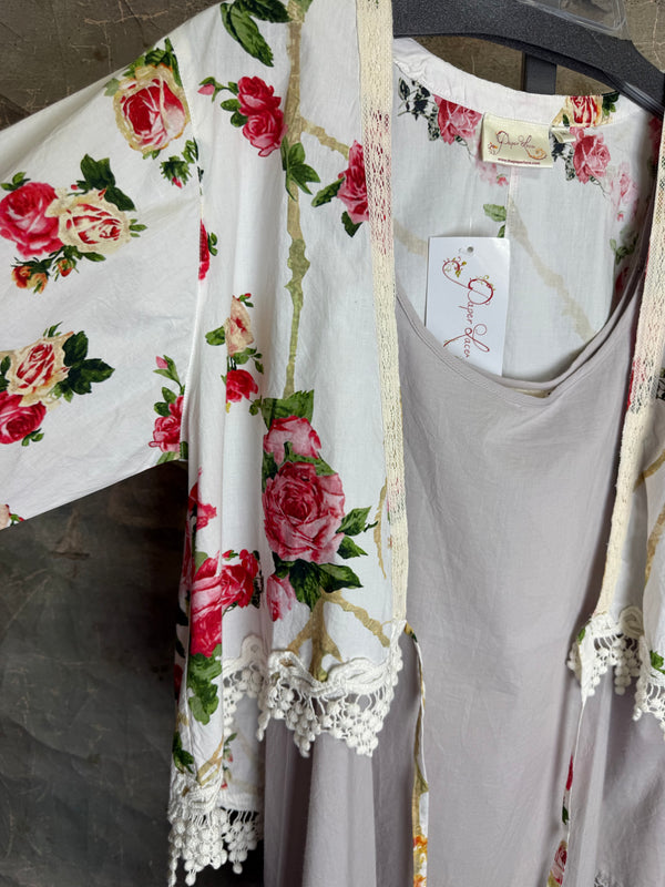 White floral kimono cardigan with pink roses and crochet lace trim displayed over gray tank top on hanger - 6