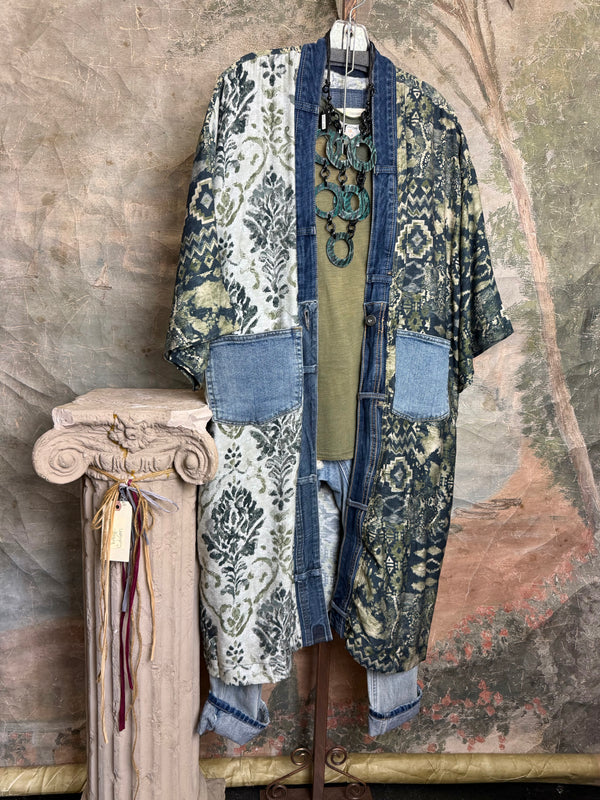 Boho patchwork denim cardigan with floral and aztec prints, large patch pockets, open front, styled with green necklace - 1