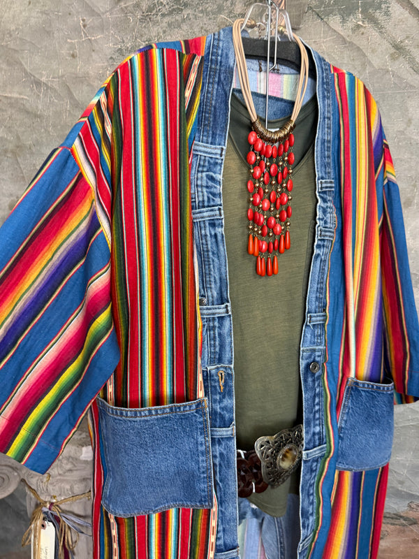 Boho serape striped duster cardigan with denim pockets, styled with red bead necklace and belt on mannequin - 6