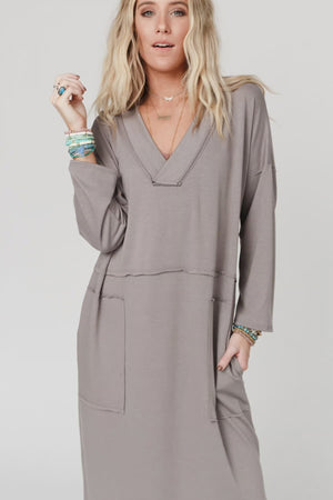 Woman wearing taupe long sleeve V-neck maxi dress with pockets and side slit, styled with platform sandals - 2