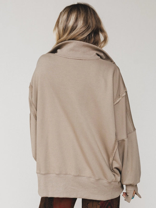 Woman wearing oversized taupe quarter-zip pullover sweatshirt with exposed seams and ribbed cuffs - 3
