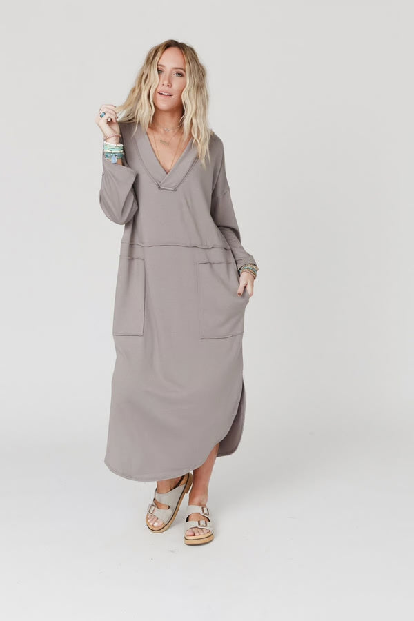 Woman wearing taupe long sleeve V-neck maxi dress with pockets and side slit, styled with platform sandals - 3