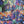 Load image into Gallery viewer, Oversized crew pullover in vibrant multicolor abstract print with flower necklace, paired with black pants on mannequin - 4
