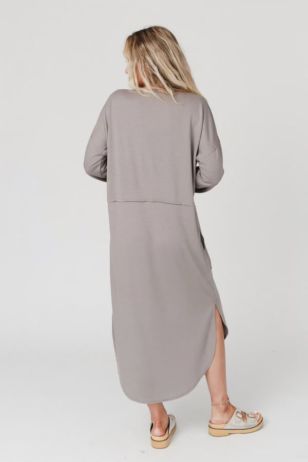Woman wearing taupe long sleeve V-neck maxi dress with pockets and side slit, styled with platform sandals - 5