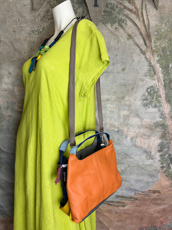 Soruka orange multicolor leather crossbody bag with gray strap on lime green linen dress mannequin - 1