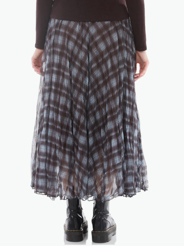 Flowy plaid midi skirt in blue-gray tones styled with patched denim jacket and pearl necklace on boutique display - 4
