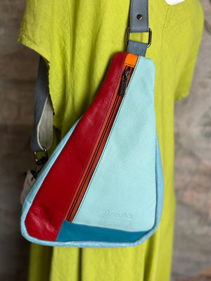 Soruka multicolor leather sling crossbody bag in light blue, red, and teal with orange zipper detail - 1